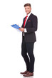 business man writes on clipboard
