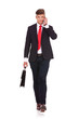 business man walks with brief & phone