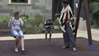 Girlfriends with kid playing on the swing