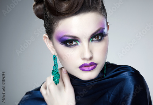 Photo: professional blue make-up and hairstyle on beautiful woman face professional blue make-up and hairstyle on beautiful woman face