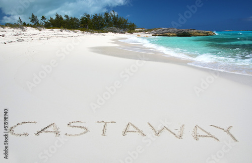 Photo: Castaway writing on a desrt beach of Little Exuma, Bahamas Castaway writing on a desrt beach of Little Exuma, Bahamas