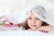 Little girl lying with pink tulips