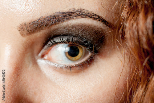 Photo: Macro shot of woman's eye with long eyelashes look Macro shot of woman's eye with long eyelashes look