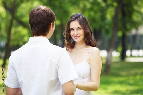 Photo: Young love Couple smiling under blue sky Young love Couple smiling under blue sky