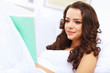 Young woman at home with a book