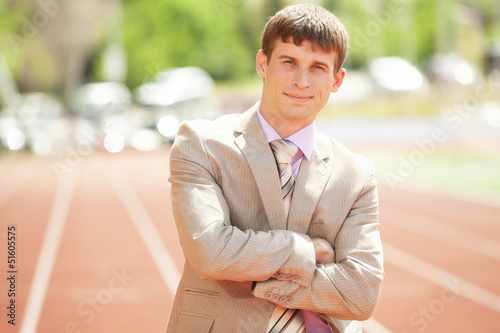 Photo: Businessman at athletic stadium and race track Businessman at athletic stadium and race track