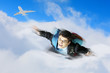 Young businessman flying with parachute on back