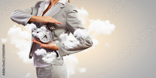 Photo: Businesswoman holding alarmclock Businesswoman holding alarmclock
