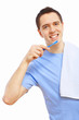 Young man at home brushing teeth