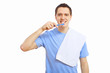 Young man at home brushing teeth