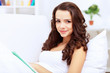 Young woman at home with a book