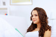 Young woman at home with a book