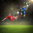 two football players striking the ball