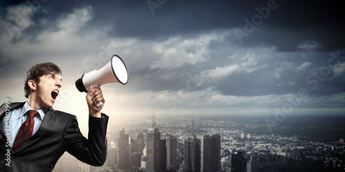 Photo: businessman with megaphone businessman with megaphone