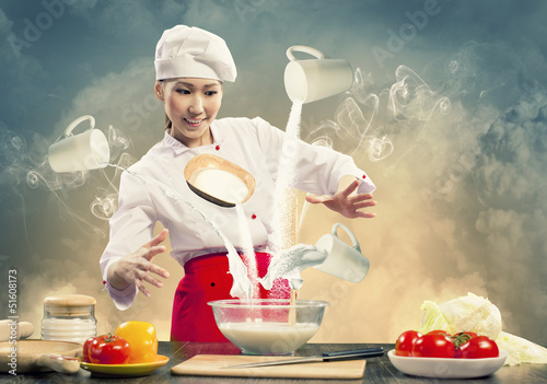 Photo: Asian female cooking with magic Asian female cooking with magic