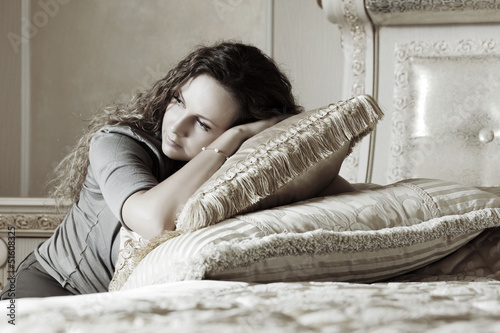 Photo: Beautiful woman in a bedroom Beautiful woman in a bedroom