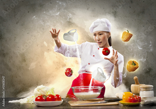 Photo: Asian female cooking with magic Asian female cooking with magic