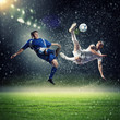 two football players striking the ball
