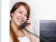Female office assistant has a call at work