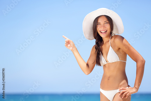 Photo: Beach woman pointing showing vacation concept Beach woman pointing showing vacation concept