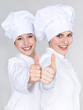 Foto: Two female apprentices for cooking show thumb up Two female apprentices for cooking show thumb up