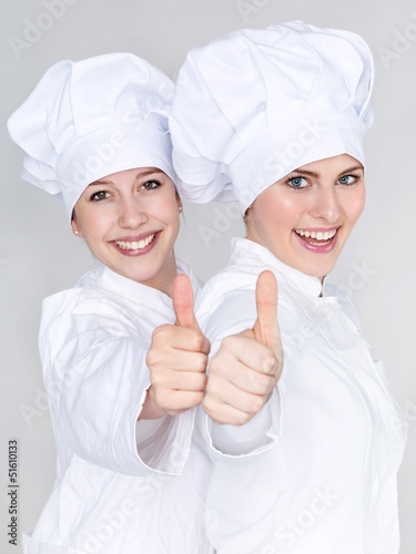 Photo: Two female apprentices for cooking show thumb up Two female apprentices for cooking show thumb up