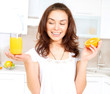 Young and Healthy Woman with Orange Juice in the Kitchen