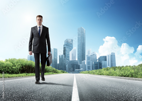 Photo: business man walking on the road business man walking on the road