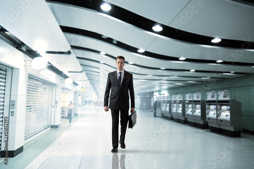Photo: business man walking in subway business man walking in subway
