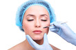 Cosmetic surgery with scalpel on young woman close up