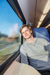 Foto: Man traveling by train, looking at the window Man traveling by train, looking at the window
