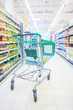 Shopping trolley with some groceries in supermarket