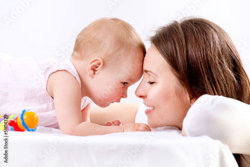Photo: Mother and Baby kissing and hugging. Happy Family Mother and Baby kissing and hugging. Happy Family