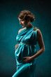 Pregnant woman in blue silk dress, beautiful pregnancy.