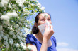 Allergic woman sneezing in handkerchief