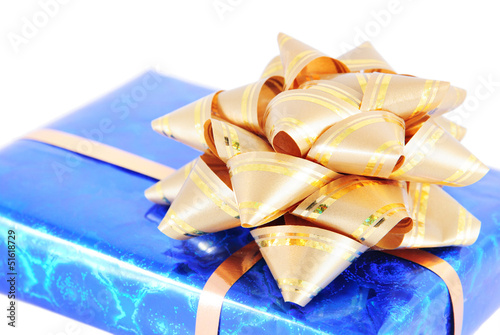 Photo: blue box with gift golden bow isolated on white blue box with gift golden bow isolated on white