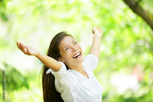 Photo: Carefree elated cheering woman in spring or summer Carefree elated cheering woman in spring or summer