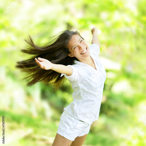 Photo: Rejoicing happy woman in flying motion Rejoicing happy woman in flying motion
