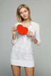 Photo: Woman in white lacy dress holding heart shape Woman in white lacy dress holding heart shape