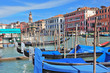 Graceful gondolas wait for passengers on the mooring