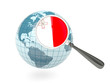 Magnified flag of malta with blue globe
