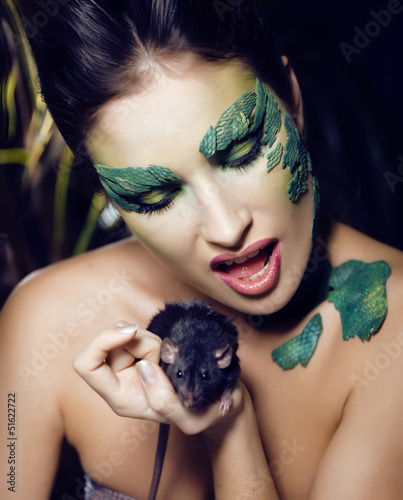 Photo: woman with creative make up like snake with rat in her hands woman with creative make up like snake with rat in her hands