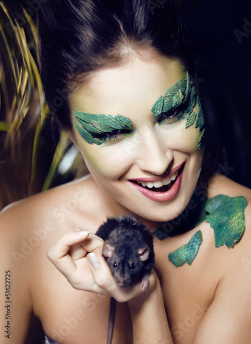 Photo: woman with creative make up like snake with rat in her hands woman with creative make up like snake with rat in her hands