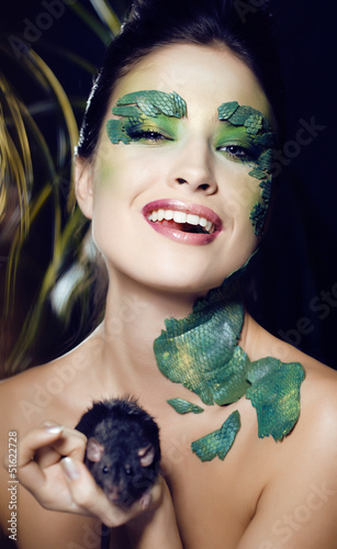 Photo: woman with creative make up like snake with rat in her hands woman with creative make up like snake with rat in her hands