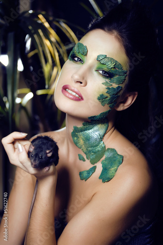 Photo: woman with creative make up like snake with rat in her hands woman with creative make up like snake with rat in her hands