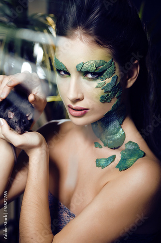 Photo: woman with creative make up like snake with rat in her hands woman with creative make up like snake with rat in her hands