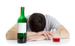 Photo: the young man sleeping at a table and a bottle with wine the young man sleeping at a table and a bottle with wine