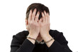 Photo: The man in handcuffs closes hands a face. The man in handcuffs closes hands a face.