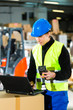 Worker with scanner and laptop at forwarding