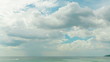 Clouds passing through the sky above the sea. Time-lapse.